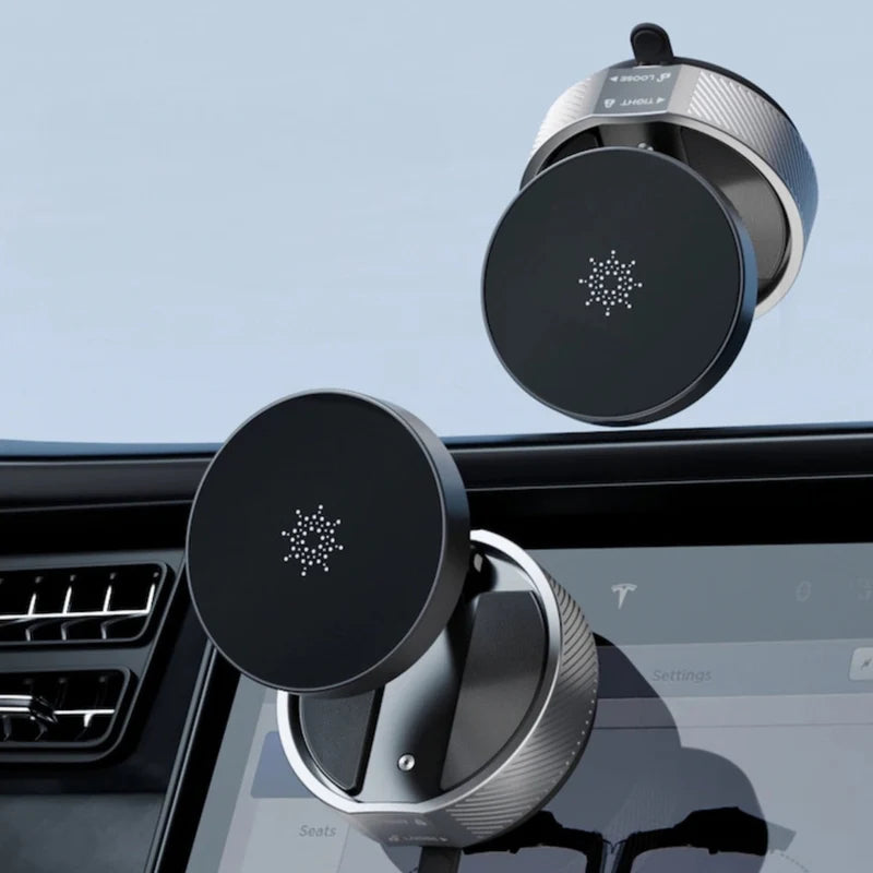Two black magnetic car mount holders on a car dashboard with a clear blue sky background.